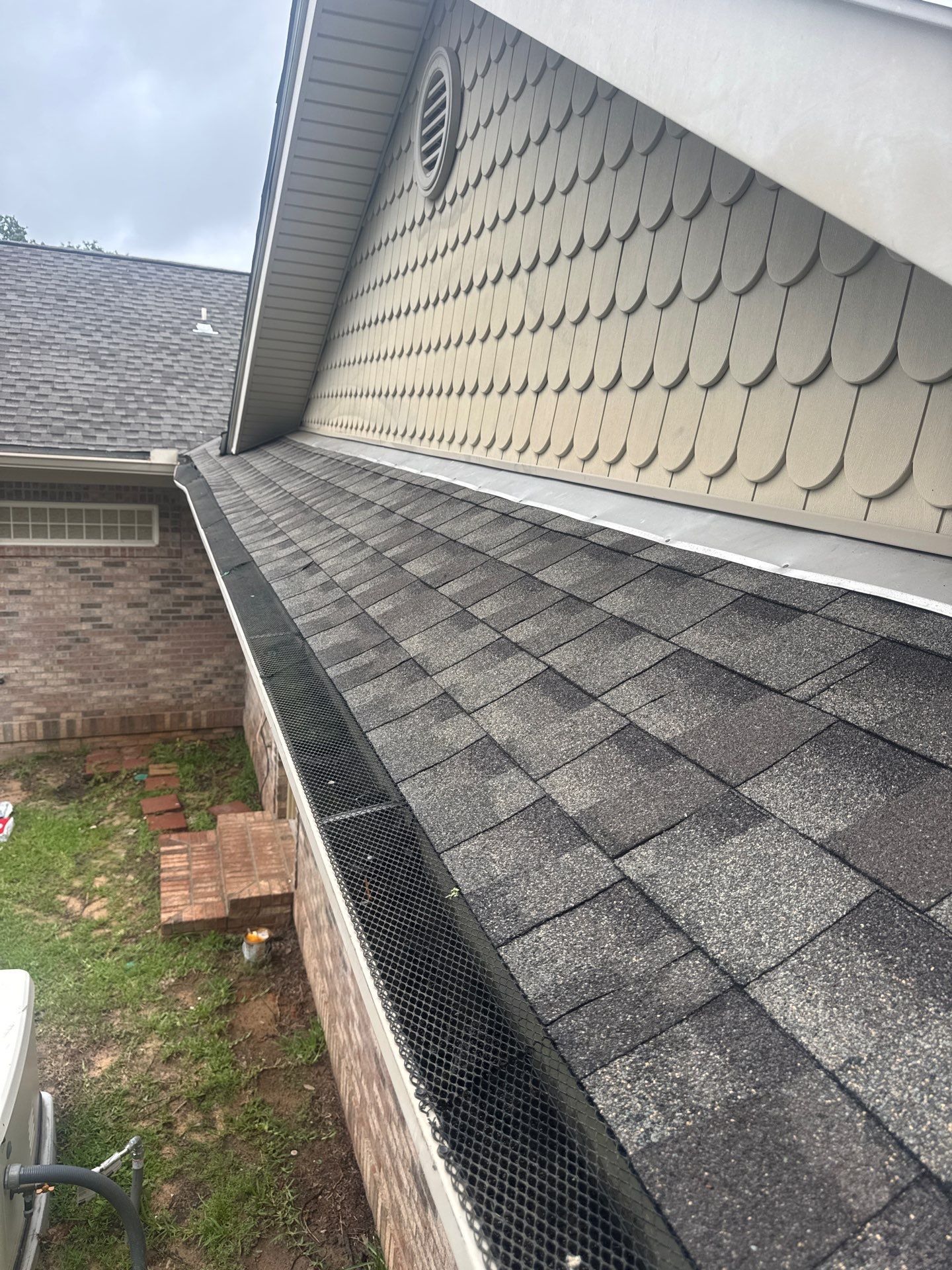 Metal wall flashing and gutter detail where a roof slope meets a vertical wall on a GD Construction roof